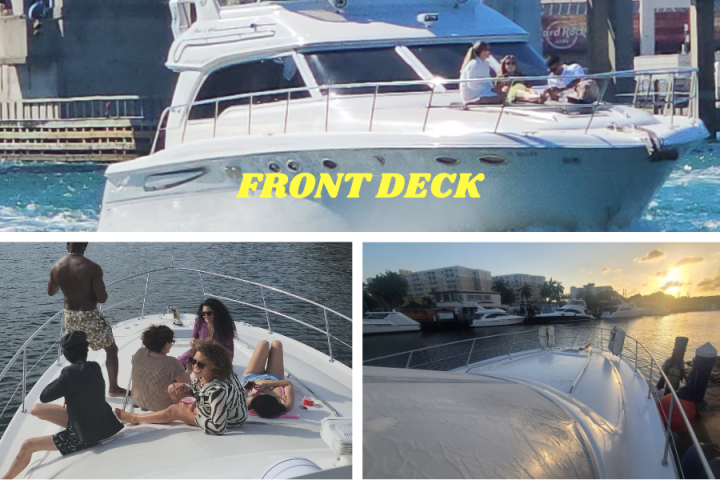 People sitting on the deck of a yacht, with water and other boats in the background.