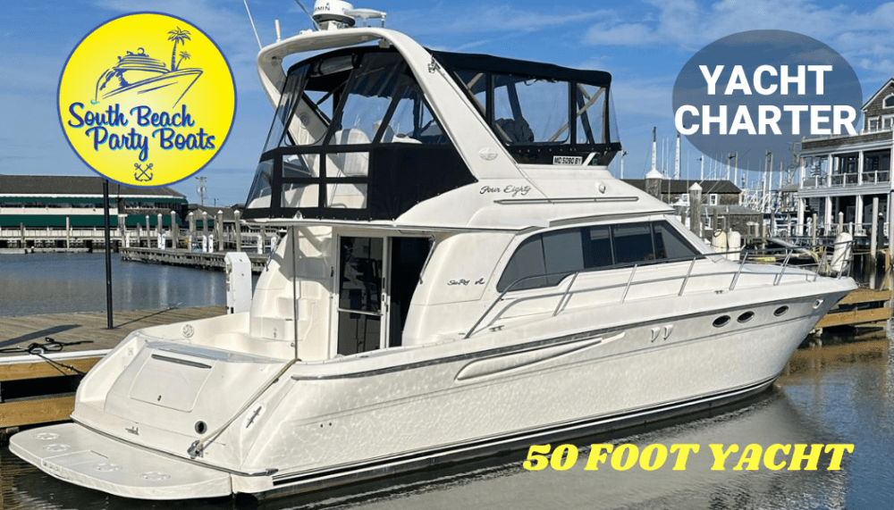 White 50-foot yacht docked at marina with yacht charter signage.