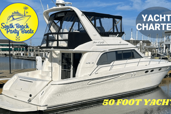 White 50-foot yacht docked at marina with yacht charter signage.