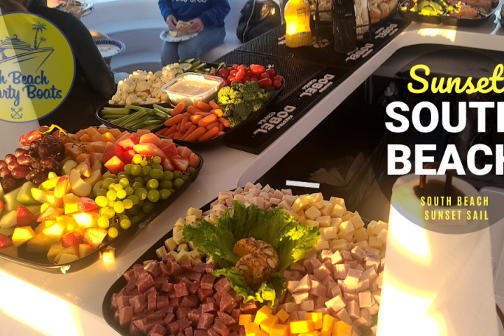 Variety of appetizers and fruits on a yacht table with South Beach Party Boats logo.