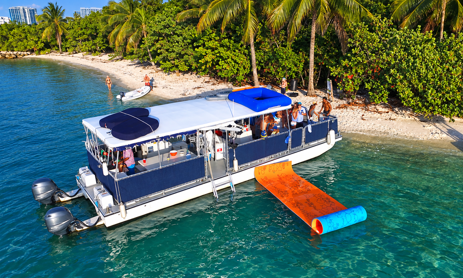 Pontoon boat with orange float, people on deck, by tropical shoreline.